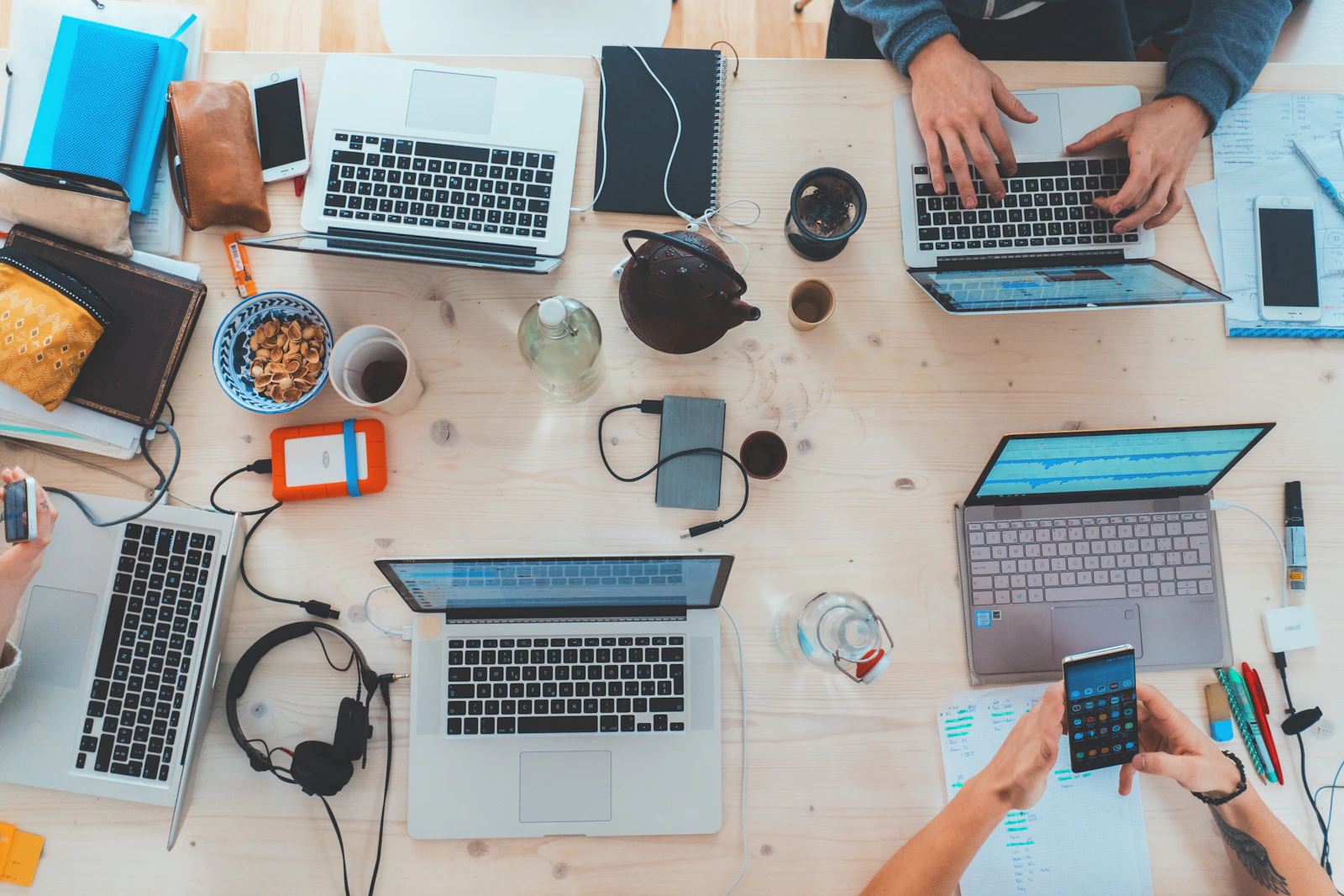 Stock photograph of people collaborating with laptops, not our team